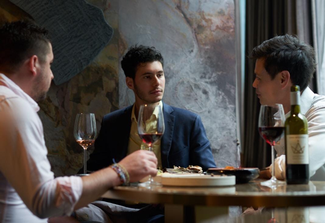 Employees talking over a glass of wine