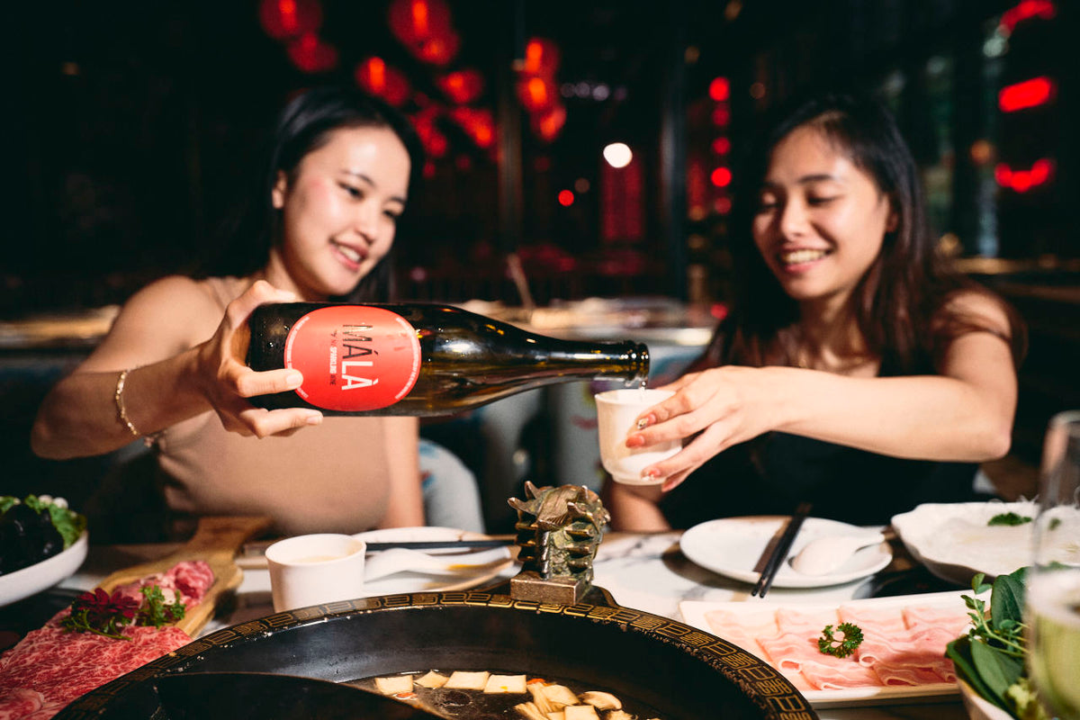 Friends sharing Mala while having spicy hot pot