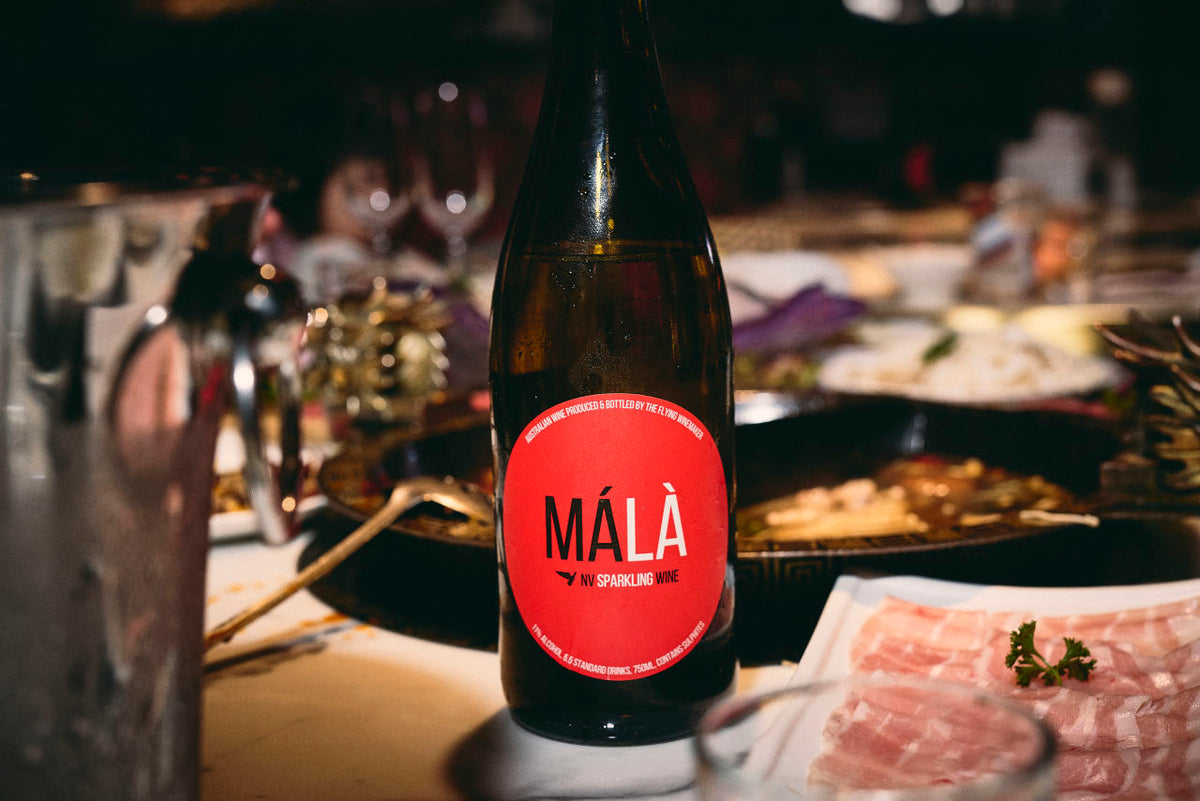 MÁLÀ sparkling wine paired with spicy Sichuan hot pot and shared dining table
